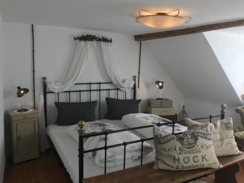 a bedroom with a bed with a black frame and pillows at Ferienwohnung Bei Der Kirch in Münsingen