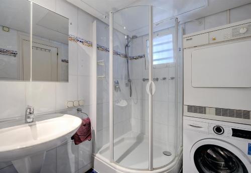 a bathroom with a sink and a washing machine at Apartment Boulevard 105 in Estepona