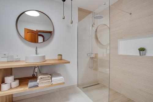 a bathroom with a shower and a sink and a mirror at Casa Ann in Arrecife