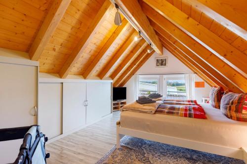 a bedroom with a bed and wooden ceilings at Ferienwohnung am Rosenberg in Stockach
