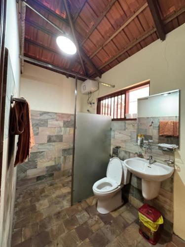 a bathroom with a toilet and a sink at Wildland Resort in Phú Quốc