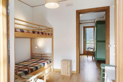 a bedroom with two bunk beds and a hallway at Villa Il Cortivo 81 in Fratta
