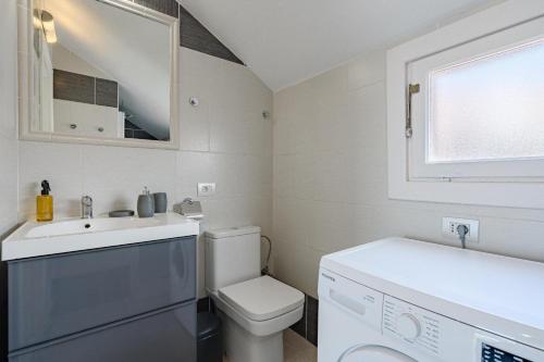 a small bathroom with a toilet and a sink at 1bed Duplex Las Americas in Playa de las Americas
