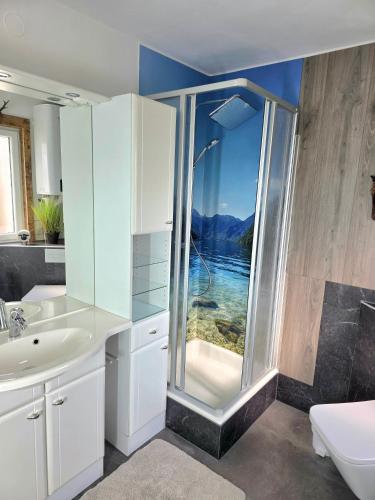 a bathroom with a shower with a view of the water at Ritschel Alm Limbach in Probstzella