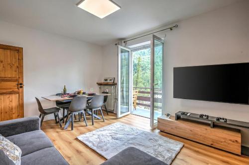 a living room with a large flat screen tv at Starkeeper Apartment - Happy Rentals in Pragelato