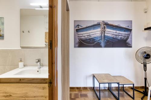 a bathroom with a sink and a boat on the wall at Casa Con Vistas Aiguablava in Tamariu