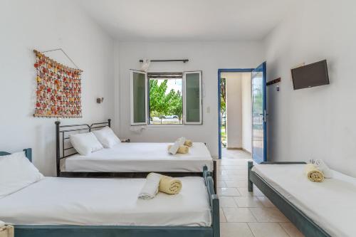 a room with three beds and a window at Perasma Studios 8 in Kipri