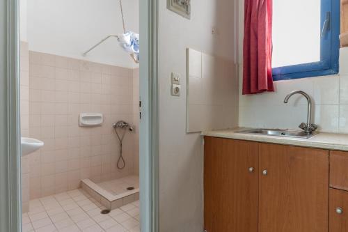 a bathroom with a sink and a shower at Perasma Studios 8 in Kipri