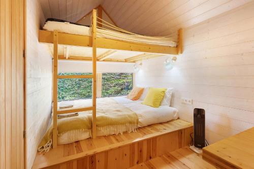 a bedroom with a bunk bed and a window at Cabanas do Alto da Coutada in Ponte de Lima