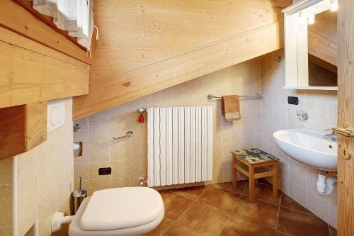 a bathroom with a white toilet and a sink at Casa Michela Mansarda in Valfurva
