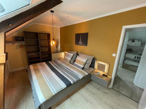 a bedroom with a bed in a room at La Maison Neuve in Béganne