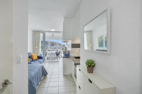 a room with a bed and a kitchen with a table at Vistas al atlantico in Puerto Rico de Gran Canaria