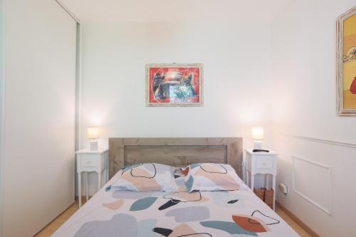 a bedroom with a bed and two night stands at T2 avec terrasse proche plages in Pléneuf-Val-André
