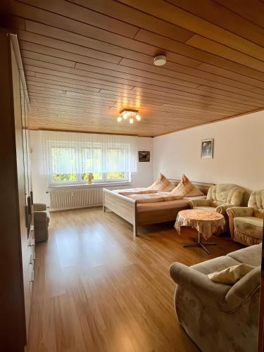 a large room with a bed and a couch at Schwarzwald-Ferienwohnung Lehmann in Oppenau