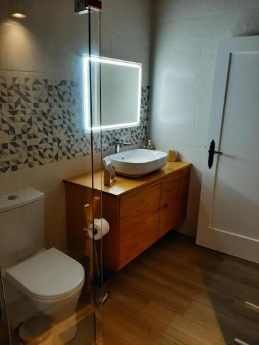 a bathroom with a sink and a toilet at Casa das Cales in Angra do Heroísmo