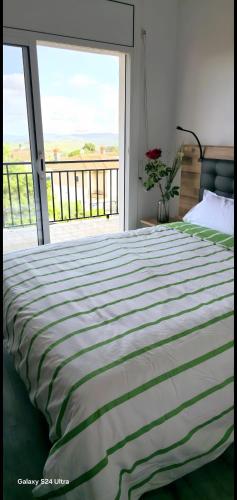 a bedroom with a large bed and a large window at Casa con mucha luz natural in Bisbal del Penedès
