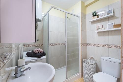 a bathroom with a shower and a sink and a toilet at Vivir Bajamar in Bajamar