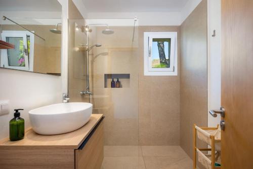 a bathroom with a white sink and a shower at Casa Inés in Cala Murada