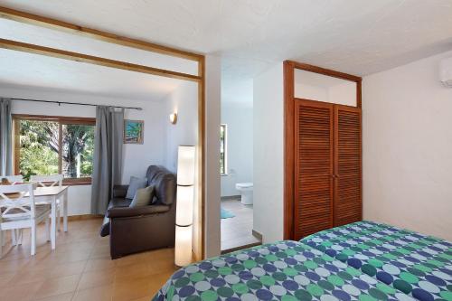 a bedroom with a bed and a living room with a table at Casa Garten in Tijarafe