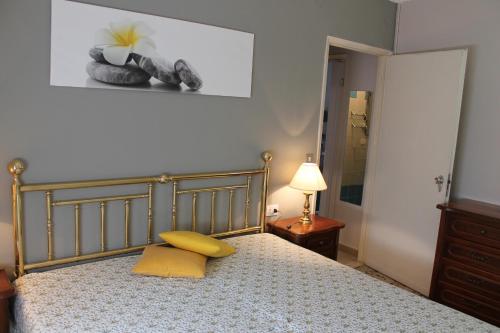 a bedroom with a bed with two yellow pillows at Favola Bella in Bardolino