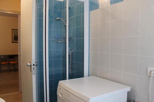 a bathroom with a toilet and a glass shower at Favola Bella in Bardolino