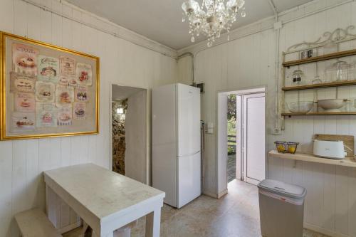 a kitchen with a white refrigerator and a table at Toscana Di Corvo in Moya