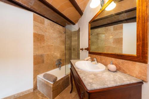 a bathroom with a sink and a tub at Es Colomer in Petra