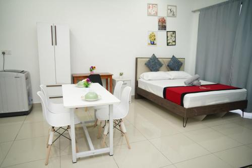 a bedroom with a bed and a table and chairs at Cozy Studio Netflix Parking Self Checkin Wifi free wifi 138 in Cyberjaya