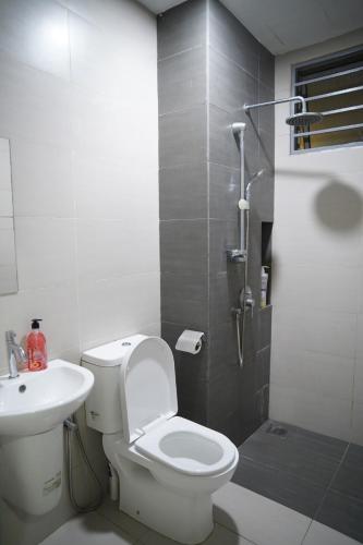 a bathroom with a toilet and a sink and a shower at Cozy Studio Netflix Parking Self Checkin Wifi free wifi 138 in Cyberjaya