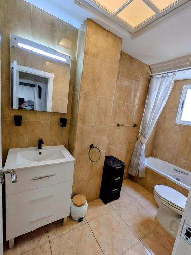 a bathroom with a sink and a toilet and a mirror at Duquesa Beach in Torrevieja