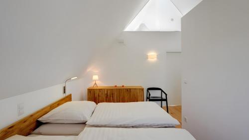 two beds in a room with white walls at Ferienhaus Wreechen 25, Haus 1 in Putbus