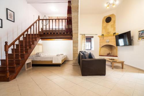 a living room with a staircase and a bed at Villa Nikolaos in Rhodes Town