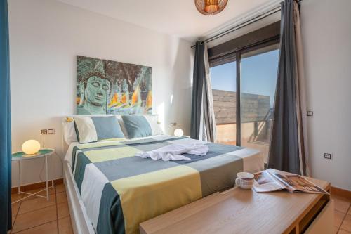 a bedroom with a large bed and a large window at Vanilla Ocean Chalet in Majanicho