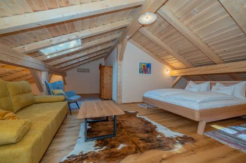 a living room with a bed and a couch at Englburger Hof in Tittling