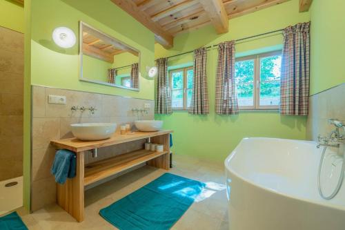 a bathroom with two sinks and a tub at Englburger Hof in Tittling