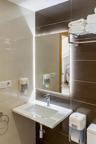 a bathroom with a sink and a mirror at Hotel L'Anxana - Sólo Adultos in Formiche Alto