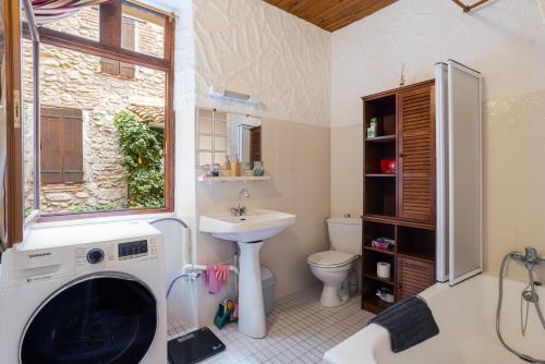 a bathroom with a sink and a washing machine at Au Petit Paris, Centre de Céret in Céret
