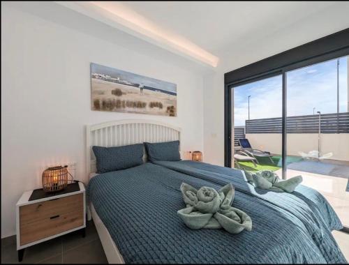 a bedroom with a bed and a large window at R-53 Corner Villa with private pool in Los Montesinos
