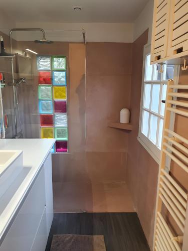 a bathroom with stained glass windows and a sink at Ô'wazo, Jolie Maison, Piscine in Lanton