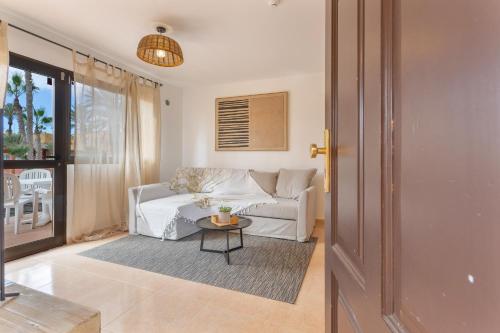 a living room with a couch and a table at Casa Piña Colada in Corralejo