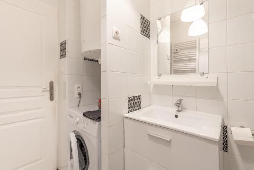 a white bathroom with a sink and a washing machine at Chalets De L'arriutort 1 - Laruns in Laruns
