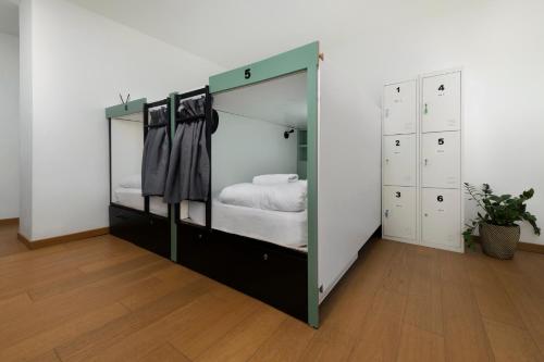 a large mirror in a room with a bed at Urban Habitat Capsule Beds in Nicosia