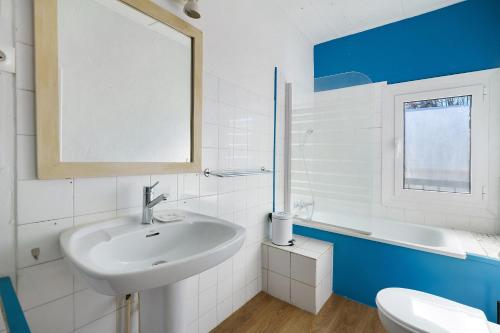 a bathroom with a sink and a toilet and a mirror at Gite De Marlas in Rieucros