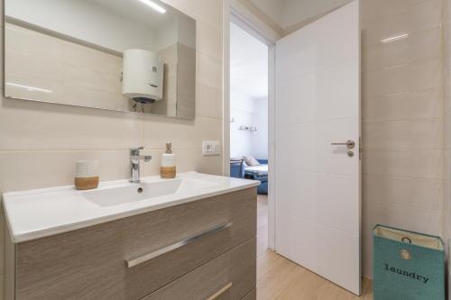a bathroom with a sink and a shower at Playa De Las Américas - Oceanfront in Costa de Adeje