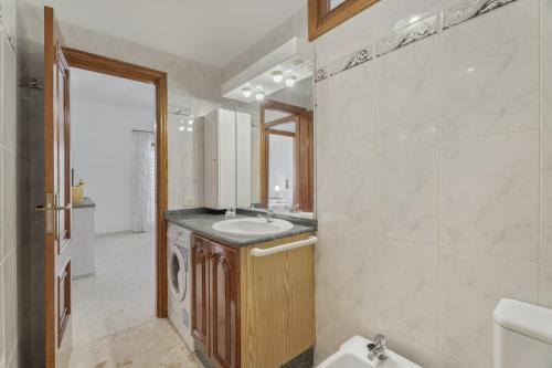 a bathroom with a sink and a mirror at Bonita Casa Annie in Abades