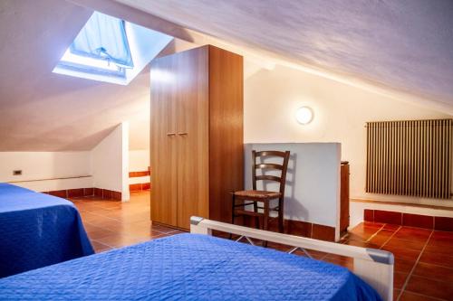 a bedroom with a bed and a wooden cabinet and a chair at Vecchio Molino in Gavorrano