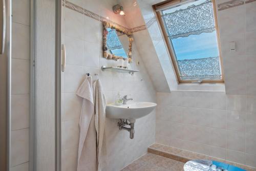 a bathroom with a sink and a shower at Haus Arvert in Koserow