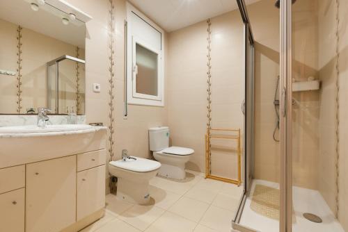 a bathroom with a toilet and a sink and a shower at Amelie Apartment in Canet de Mar