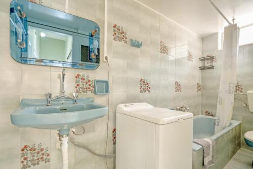 a bathroom with a sink and a toilet and a mirror at El Padre Residence in Sívros