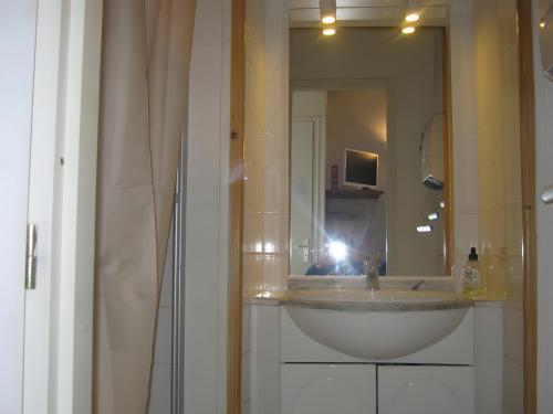 a bathroom with a sink and a large mirror at Studio chambre d'hôte in Panazol